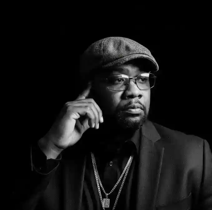 EuphoricMusic DJ in a black suit and flat cap